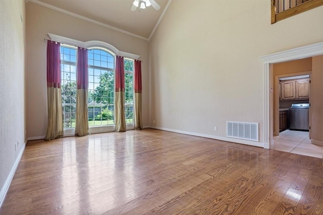 4204 Warbal Trl, Rogers, AR 72758 - unfurnished room featuring crown molding, light wood-style floors, a ceiling fan, high vaulted ceiling, and washer / dryer