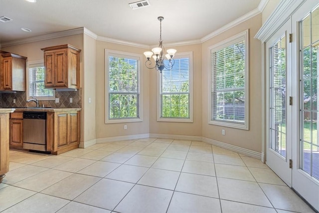 4204 Warbal Trl, Rogers, AR 72758 - kitchen featuring dishwasher, brown cabinetry, light tile patterned floors, decorative backsplash, and a chandelier