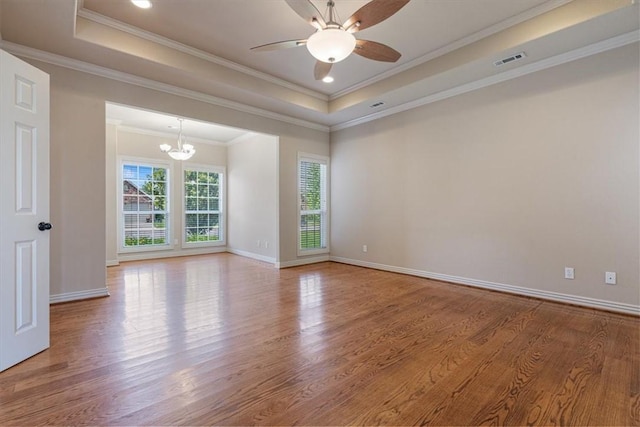 4204 Warbal Trl, Rogers, AR 72758 - spare room with wood finished floors, a chandelier, a tray ceiling, a ceiling fan, and baseboards