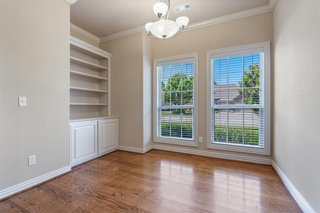 4204 Warbal Trl, Rogers, AR 72758 - spare room with ornamental molding, a chandelier, wood finished floors, and baseboards