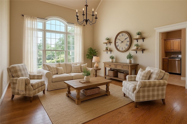 4204 Warbal Trl, Rogers, AR 72758 - living room featuring light wood-style flooring, a chandelier, a towering ceiling, and crown molding