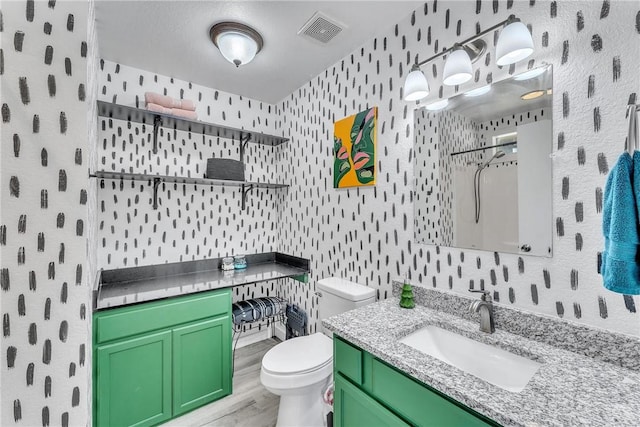 20640 Hillcrest Dr, Springdale, AR 72764 - bathroom with a shower, toilet, vanity, wallpapered walls, and wood finished floors