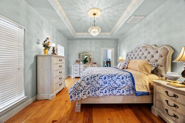 815 James Pl, West Fork, AR 72774 - bedroom with a raised ceiling, a chandelier, light wood finished floors, baseboards, and ornamental molding