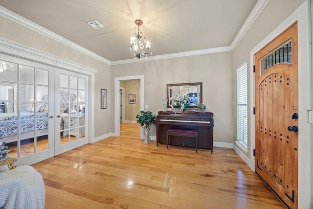 815 James Pl, West Fork, AR 72774 - entrance foyer featuring a chandelier, baseboards, crown molding, light wood-type flooring, and french doors