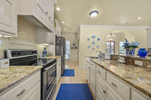 815 James Pl, West Fork, AR 72774 - kitchen featuring stainless steel appliances, ornamental molding, arched walkways, a sink, and decorative backsplash