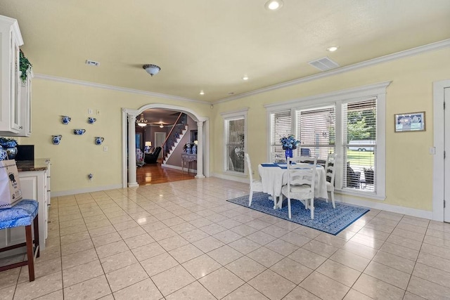 815 James Pl, West Fork, AR 72774 - dining space featuring light tile patterned floors, arched walkways, crown molding, baseboards, and stairs