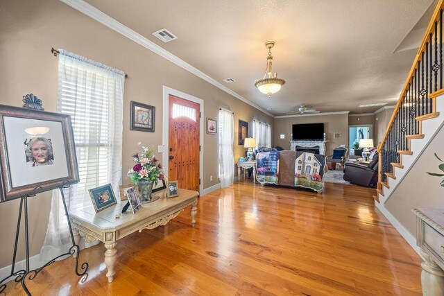 815 James Pl, West Fork, AR 72774 - living room with ceiling fan, stairs, light wood-style floors, ornamental molding, and baseboards