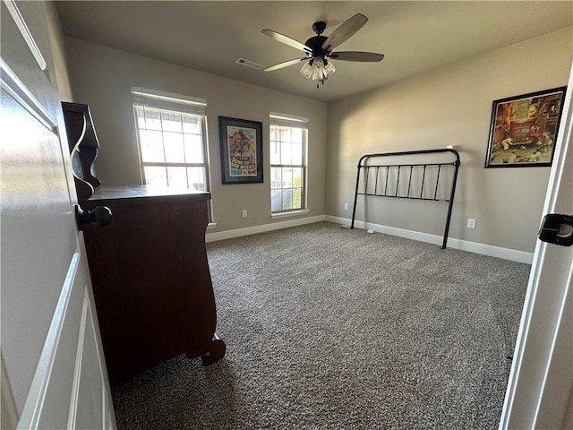 400 Fox Cir, Pea Ridge, AR 72751 - unfurnished bedroom featuring multiple windows, baseboards, carpet, and ceiling fan