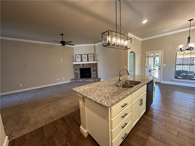 400 Fox Cir, Pea Ridge, AR 72751 - kitchen with a sink, a chandelier, a ceiling fan, black dishwasher, and a brick fireplace