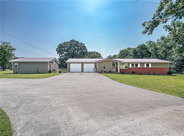 8754 N 7th Hwy, Harrison, AR 72601 - ranch-style home featuring a garage, a front lawn, concrete driveway, and metal roof