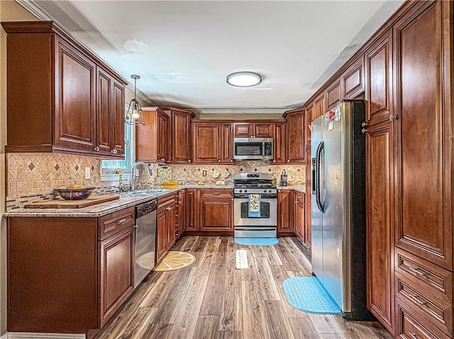 8754 N 7th Hwy, Harrison, AR 72601 - kitchen with stainless steel appliances, light wood-style floors, decorative backsplash, and decorative light fixtures