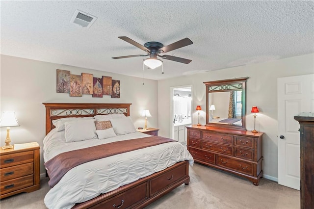 350 S Wildwood Dr Unit C15, Branson, MO 65616 - bedroom with light colored carpet, ensuite bath, a textured ceiling, and a ceiling fan