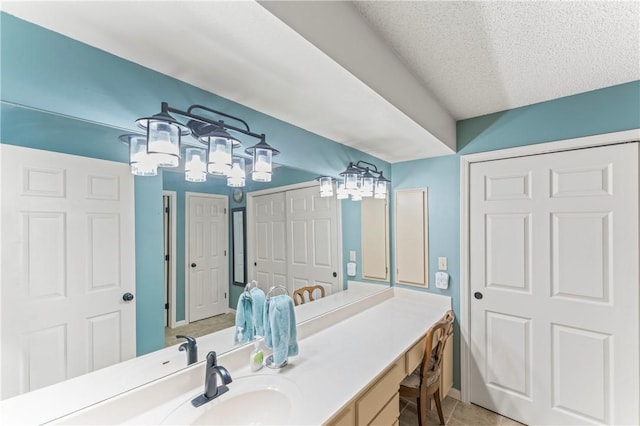 350 S Wildwood Dr Unit C15, Branson, MO 65616 - bathroom featuring vanity, baseboards, tile patterned floors, and a textured ceiling