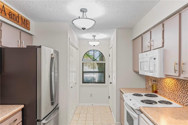 350 S Wildwood Dr Unit C15, Branson, MO 65616 - kitchen featuring white appliances, light countertops, a textured ceiling, tasteful backsplash, and baseboards