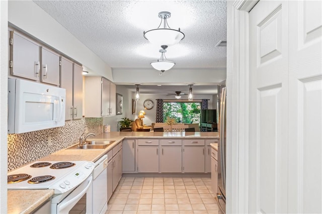 350 S Wildwood Dr Unit C15, Branson, MO 65616 - kitchen with white appliances, a sink, light countertops, decorative backsplash, and a textured ceiling