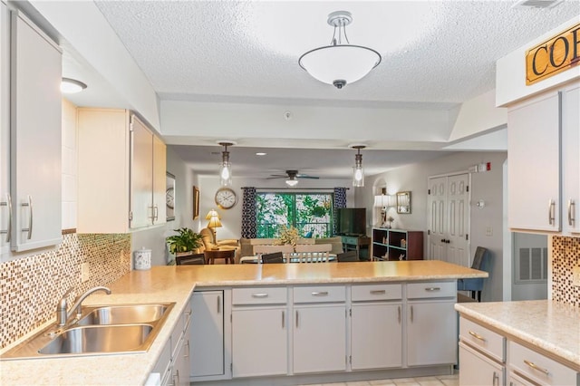 350 S Wildwood Dr Unit C15, Branson, MO 65616 - kitchen with a sink, light countertops, decorative backsplash, a ceiling fan, and a textured ceiling
