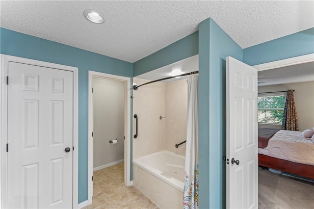 350 S Wildwood Dr Unit C15, Branson, MO 65616 - ensuite bathroom featuring shower / tub combo with curtain, a textured ceiling, and baseboards