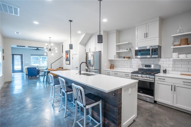 808 S Locust Ave, Fayetteville, AR 72701 - kitchen featuring stainless steel appliances, open shelves, concrete floors, backsplash, and ceiling fan