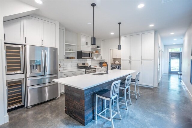 808 S Locust Ave, Fayetteville, AR 72701 - kitchen with appliances with stainless steel finishes, finished concrete flooring, open shelves, beverage cooler, and backsplash