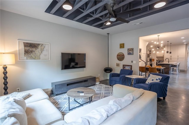 808 S Locust Ave, Fayetteville, AR 72701 - living area with concrete floors, ceiling fan, and a chandelier