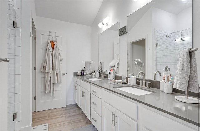 429 SW B St, Bentonville, AR 72712 - bathroom featuring double vanity, a stall shower, and wood finished floors