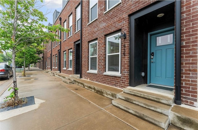 429 SW B St, Bentonville, AR 72712 - doorway to property featuring brick siding