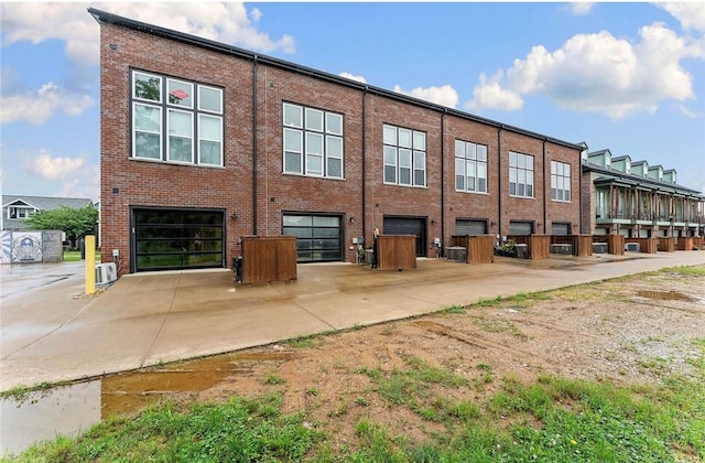 429 SW B St, Bentonville, AR 72712 - view of property featuring a garage and central AC