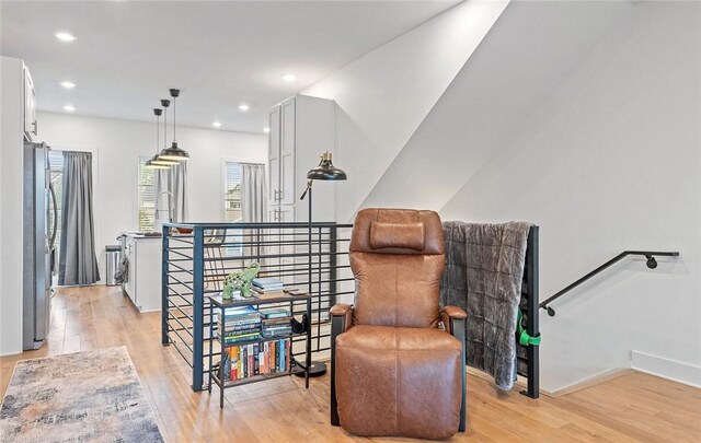 429 SW B St, Bentonville, AR 72712 - living area with an upstairs landing, light wood-style flooring, recessed lighting, and baseboards