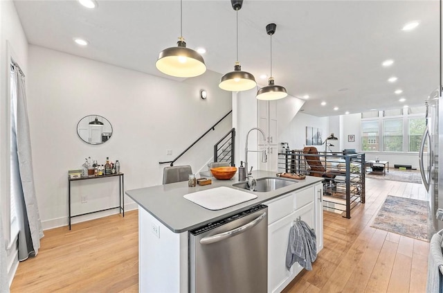 429 SW B St, Bentonville, AR 72712 - kitchen with dishwasher, a sink, light wood-type flooring, white cabinetry, and an island with sink