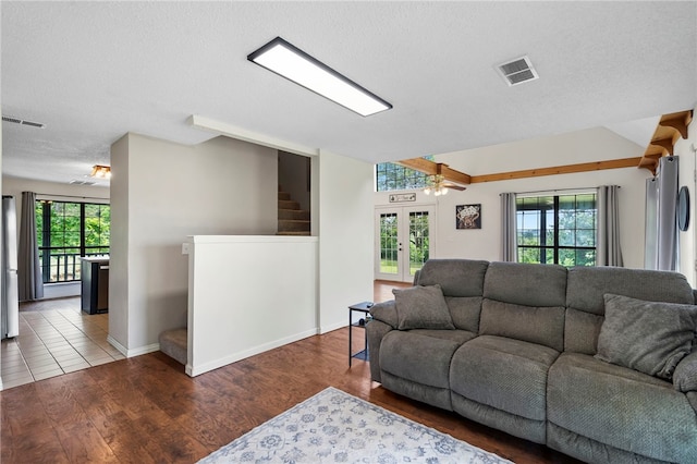 13004 Canehill Rd, Lincoln, AR 72744 - living area with plenty of natural light, wood finished floors, ceiling fan, and a textured ceiling