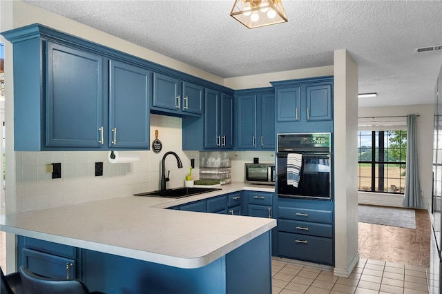 13004 Canehill Rd, Lincoln, AR 72744 - kitchen with oven, a sink, blue cabinetry, stainless steel microwave, and a peninsula
