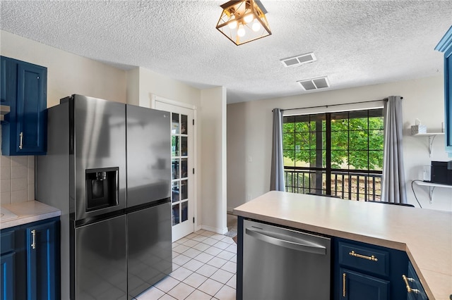 13004 Canehill Rd, Lincoln, AR 72744 - kitchen featuring appliances with stainless steel finishes, blue cabinetry, a peninsula, light countertops, and a textured ceiling