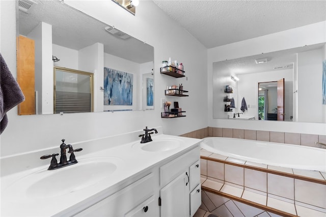 13004 Canehill Rd, Lincoln, AR 72744 - bathroom with double vanity, a garden tub, a textured ceiling, tile patterned flooring, and a shower stall