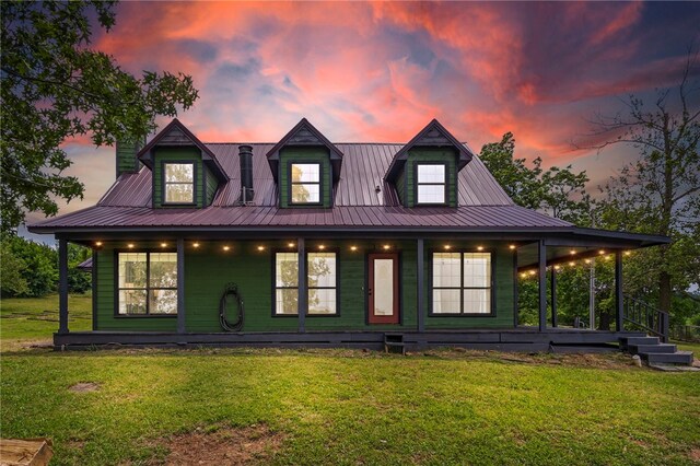 13004 Canehill Rd, Lincoln, AR 72744 - rear view of house with covered porch, a lawn, and metal roof