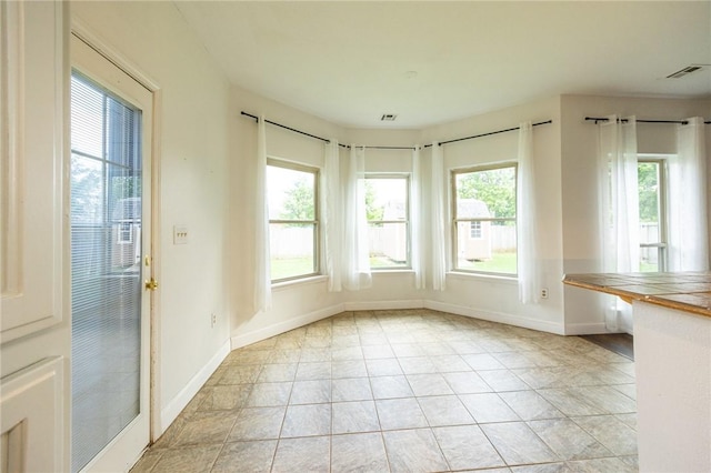 1813 SW Pine Ave, Bentonville, AR 72713 - unfurnished dining area featuring baseboards