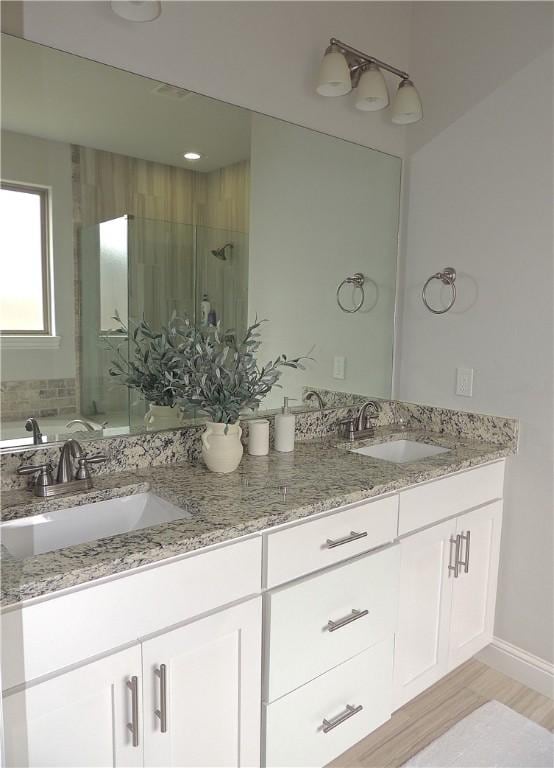1601 Cavern Springs Way, Cave Springs, AR 72718 - bathroom featuring double vanity, a stall shower, and wood finished floors
