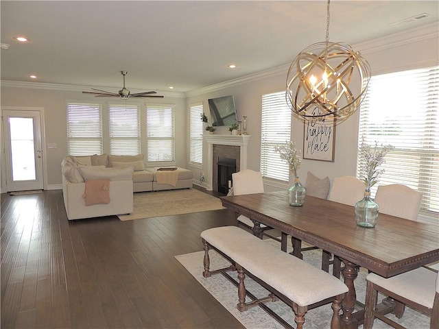 1601 Cavern Springs Way, Cave Springs, AR 72718 - dining space featuring a chandelier, crown molding, a fireplace, dark wood-style flooring, and baseboards