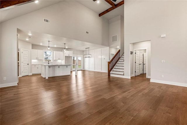 1221 Red Maple St, Centerton, AR 72719 - unfurnished living room with high vaulted ceiling, dark wood-style floors, baseboards, stairs, and beamed ceiling