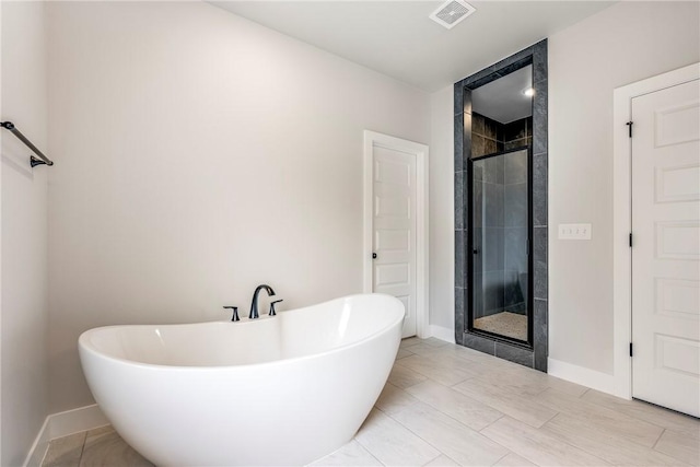 1221 Red Maple St, Centerton, AR 72719 - full bath featuring a freestanding tub, a stall shower, and baseboards