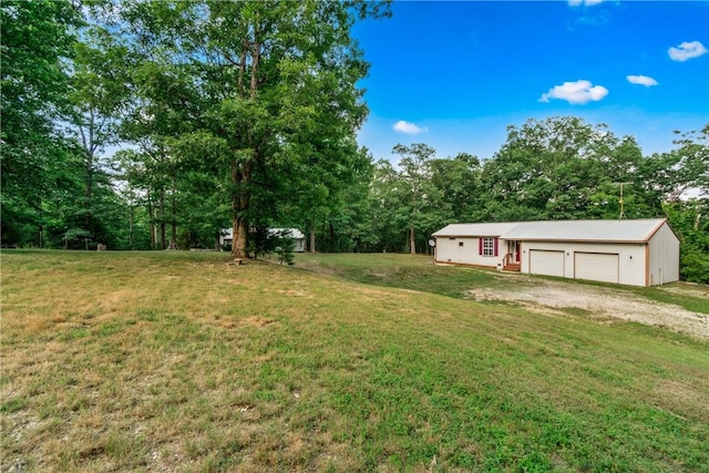11648 Ventris Rd, Garfield, AR 72732 - view of green lawn featuring driveway and a detached garage