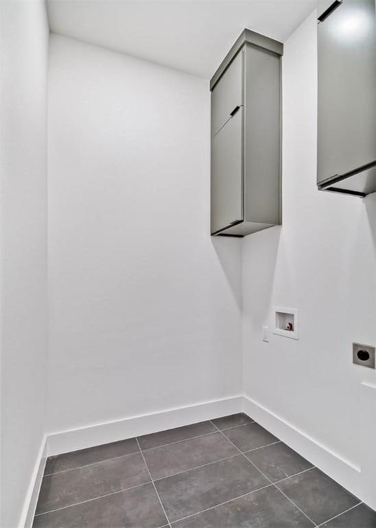 1 Breeghle Ln, Bella Vista, AR 72714 - laundry room with hookup for an electric dryer, dark tile patterned floors, cabinet space, and hookup for a washing machine