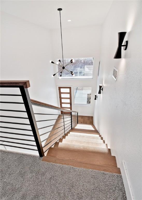 1 Breeghle Ln, Bella Vista, AR 72714 - stairway featuring a chandelier and a high ceiling