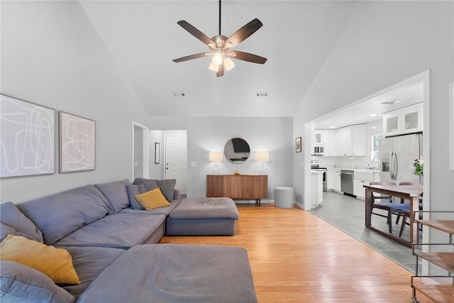 704 Del Cir, Lowell, AR 72745 - living room featuring high vaulted ceiling, ceiling fan, and light wood-style flooring