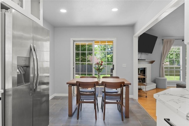 704 Del Cir, Lowell, AR 72745 - dining area with recessed lighting, a fireplace with raised hearth, and baseboards