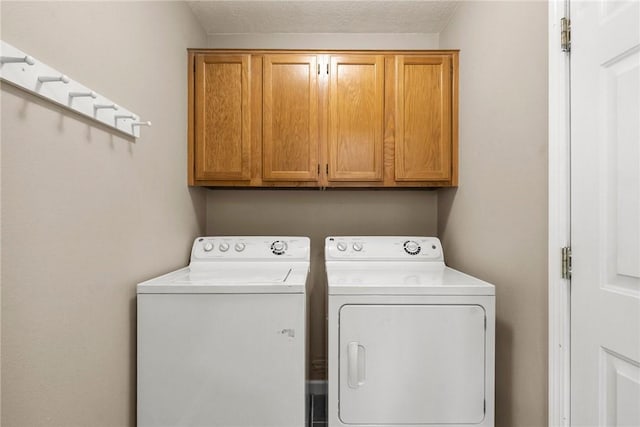 704 Del Cir, Lowell, AR 72745 - laundry room featuring cabinet space and separate washer and dryer
