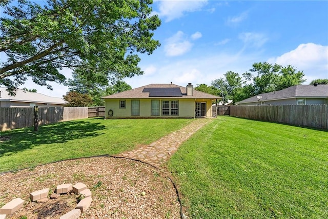 704 Del Cir, Lowell, AR 72745 - rear view of house with solar panels and a chimney