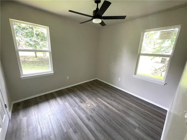 471925 807th Rd, Stilwell, OK 74960 - spare room featuring healthy amount of natural light, dark wood finished floors, ceiling fan, and baseboards