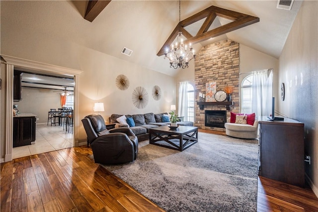 8266 Anna Maria Ave, Springdale, AR 72762 - living area with wood-type flooring, a fireplace, a chandelier, high vaulted ceiling, and baseboards