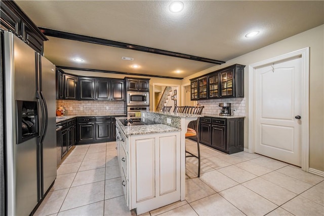 8266 Anna Maria Ave, Springdale, AR 72762 - kitchen with appliances with stainless steel finishes, a kitchen bar, backsplash, light tile patterned flooring, and glass insert cabinets