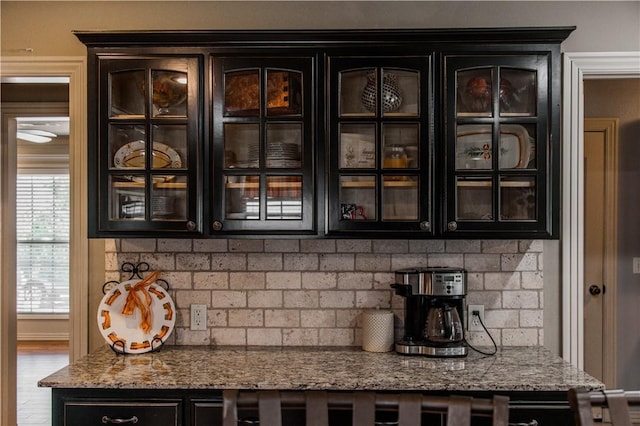 8266 Anna Maria Ave, Springdale, AR 72762 - kitchen view of dark cabinetry, glass insert cabinets, and light stone counters